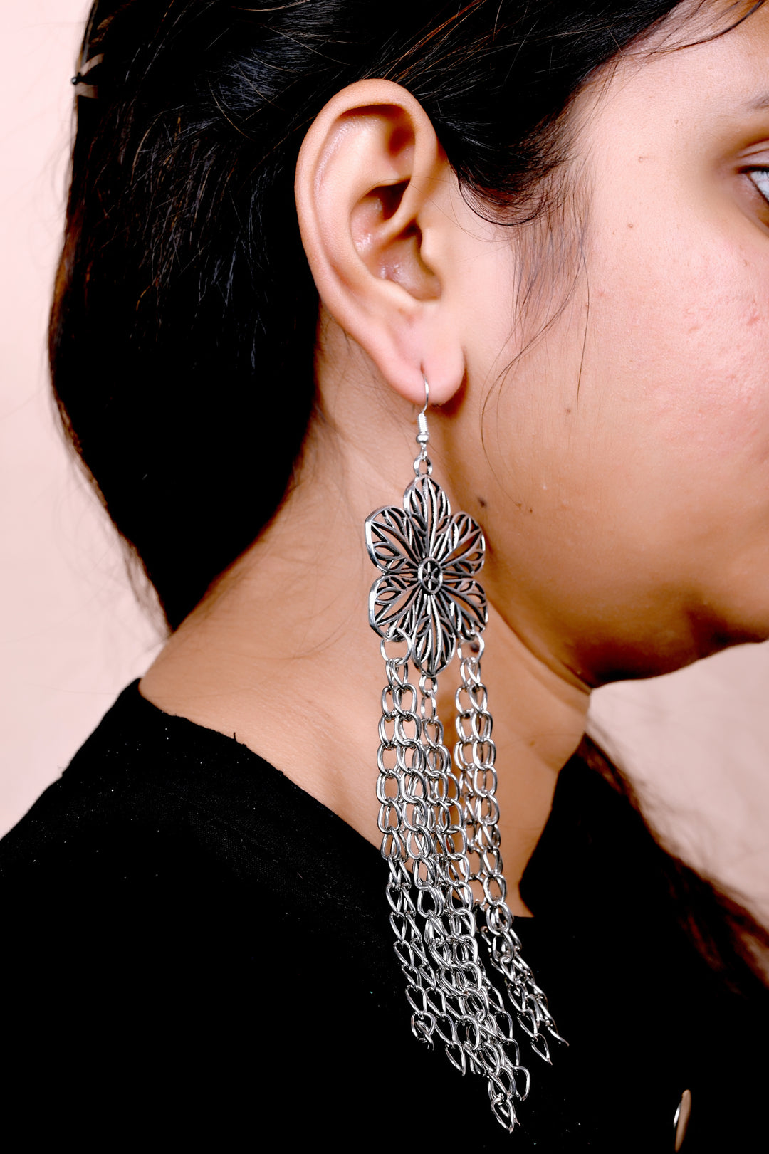 Stunning Flower Shaped Metal Big Charm Earring Styled With Multi Layered Metal Chain Hanging At The Bottom