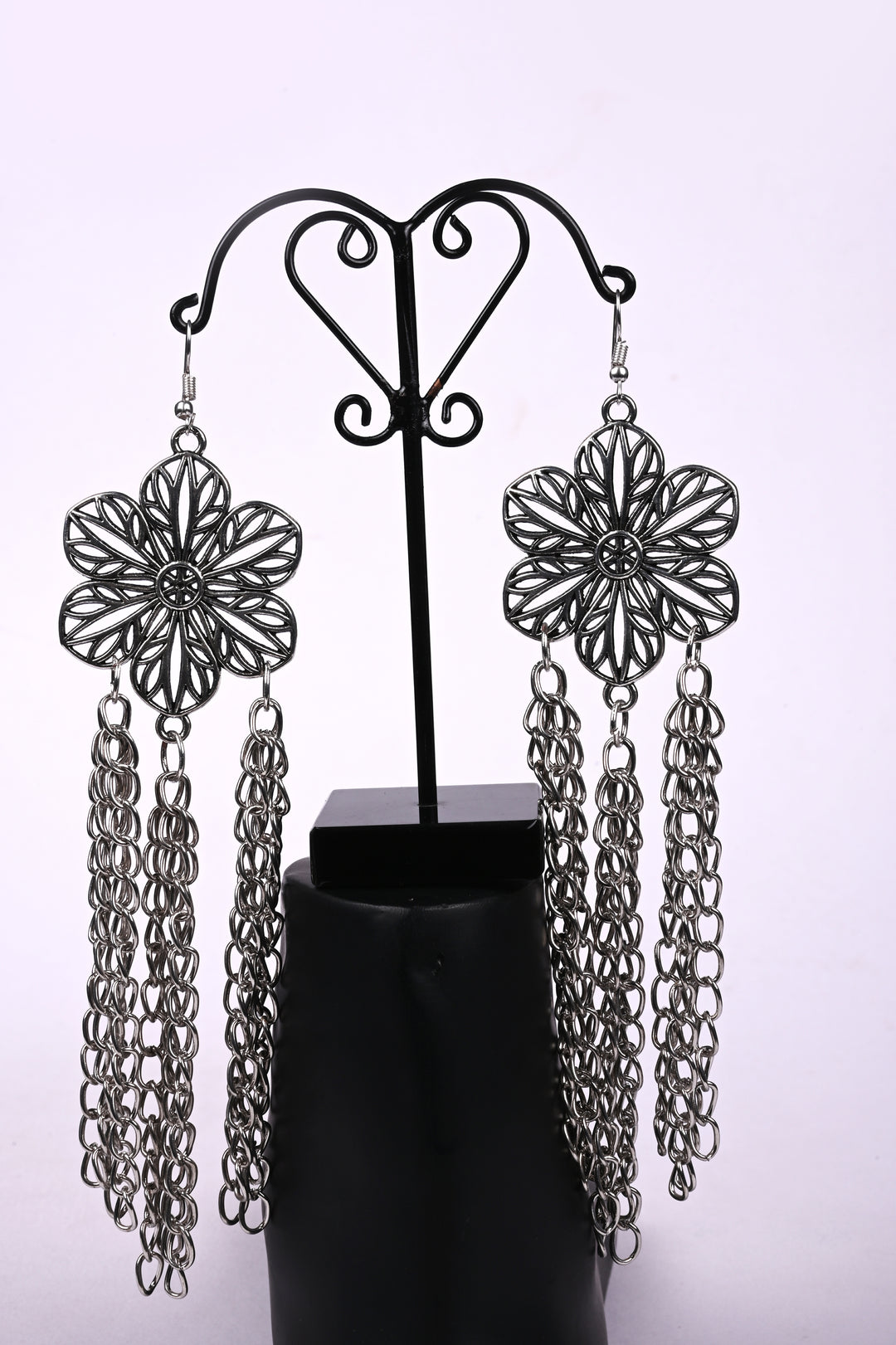 Stunning Flower Shaped Metal Big Charm Earring Styled With Multi Layered Metal Chain Hanging At The Bottom