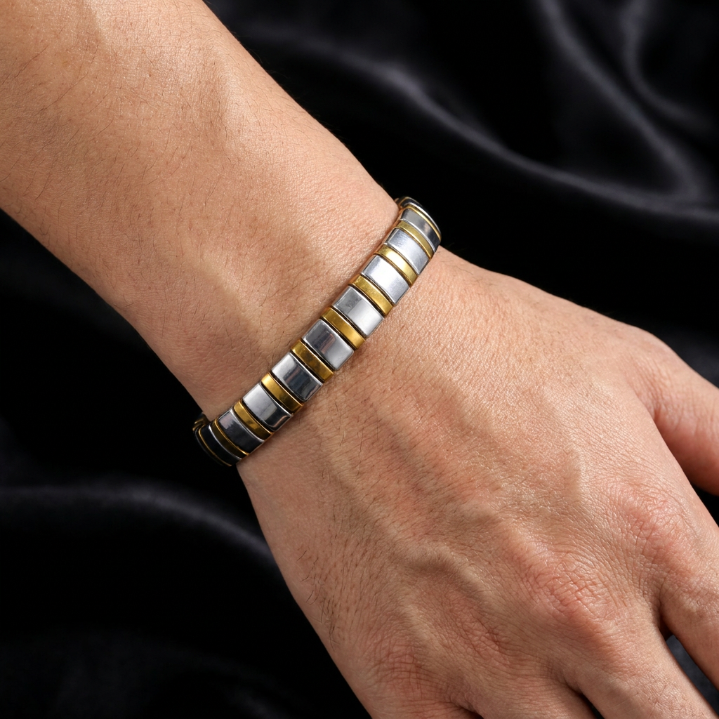 Delemon featuring a uniform two-tone stretch bracelet alternating polished silver-grey hematite blocks with slim gold metallic spacer beads