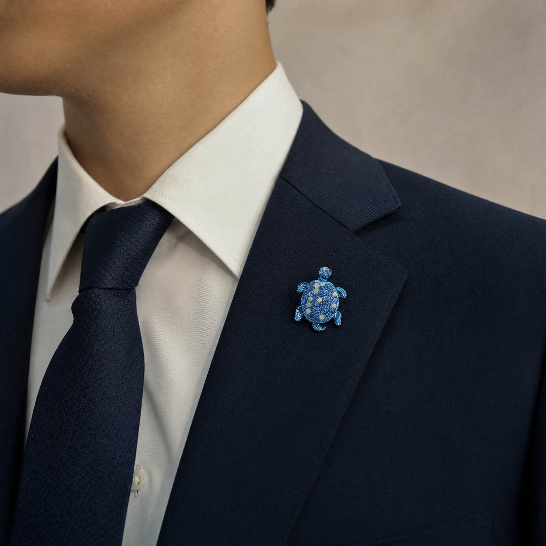 Metallic blue sea turtle brooch pin encrusted with sapphire blue and opal-tone crystals 