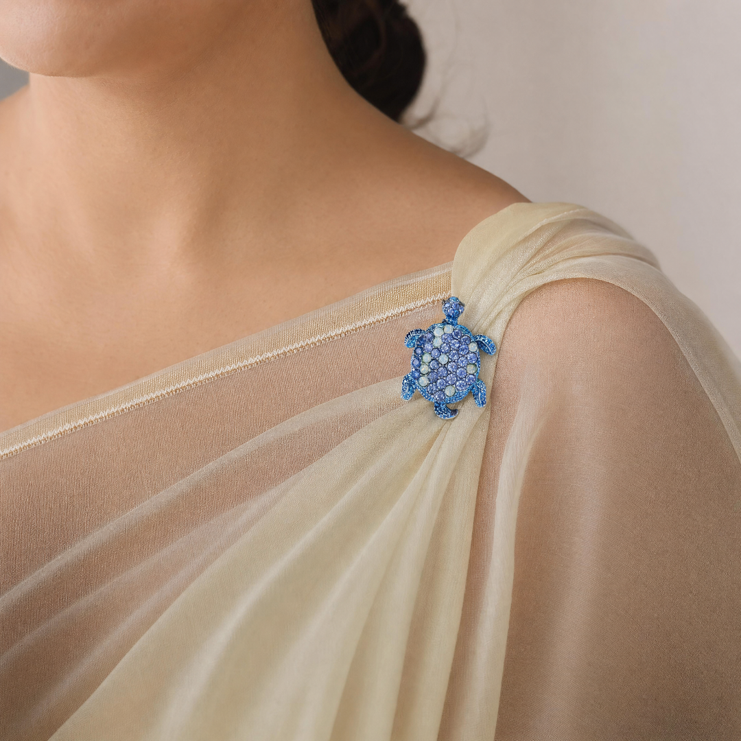 Metallic blue sea turtle brooch pin encrusted with sapphire blue and opal-tone crystals 