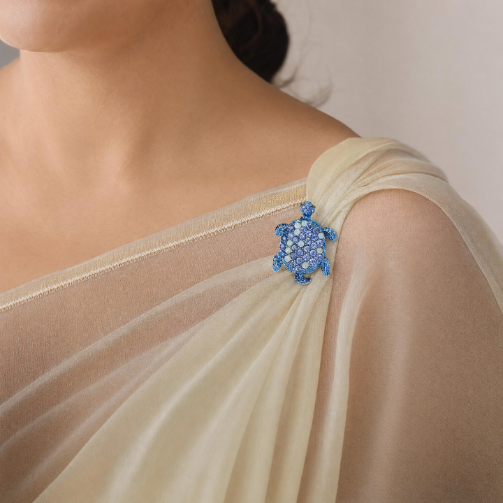 Metallic blue sea turtle brooch pin encrusted with sapphire blue and opal-tone crystals 