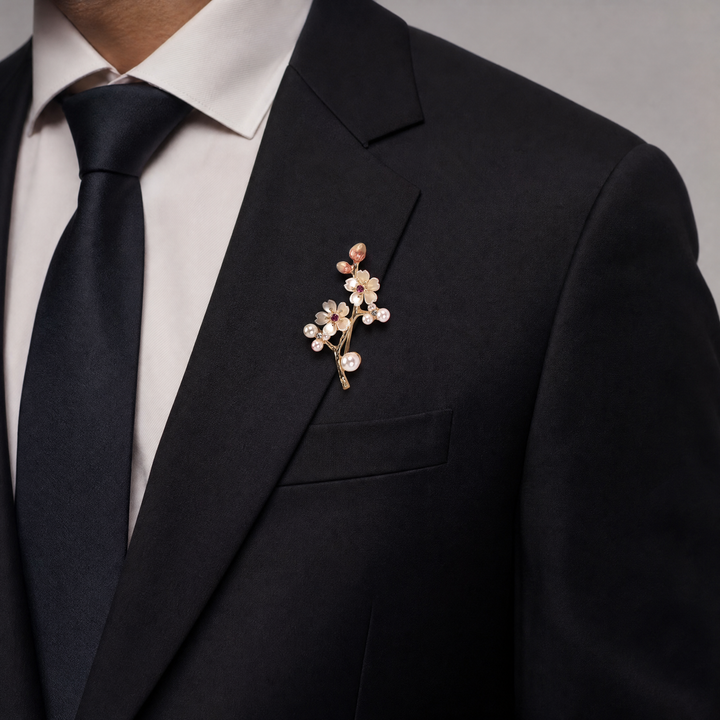Gold-tone cherry blossom branch brooch pin with pearlescent white enamel flowers, ruby pink crystals, and pearl