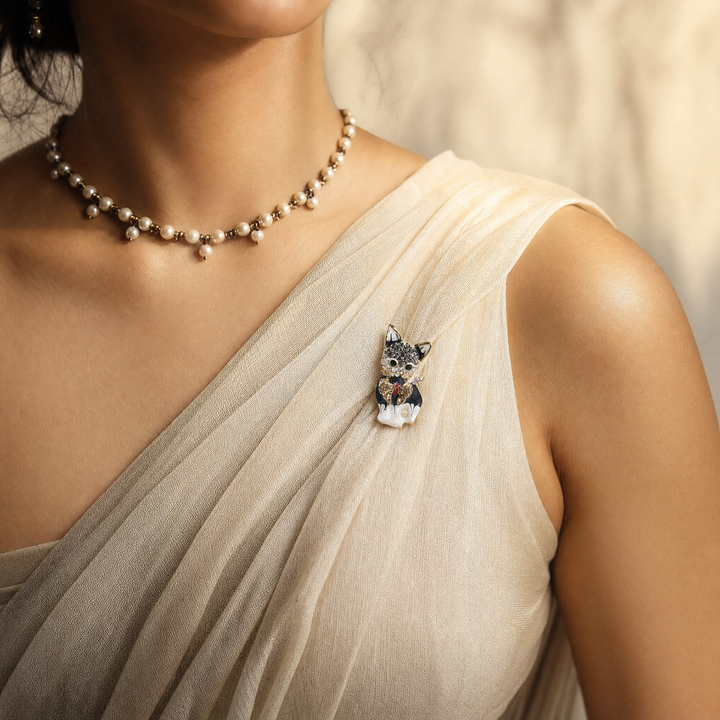 Gold-tone sitting French Bulldog brooch pin with black and white enamel finish, crystal bow tie.