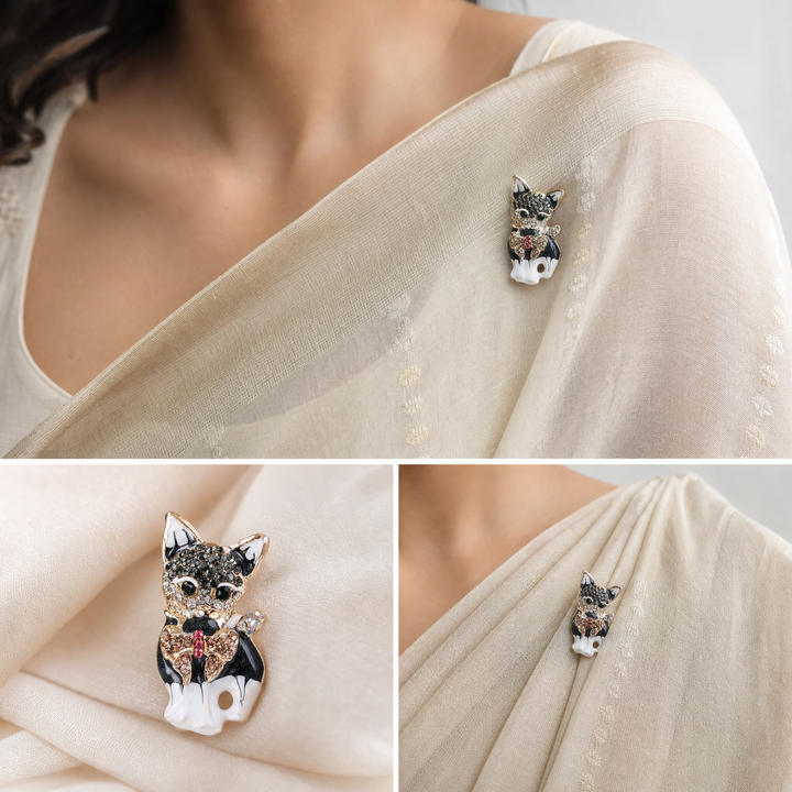 Gold-tone sitting French Bulldog brooch pin with black and white enamel finish, crystal bow tie.