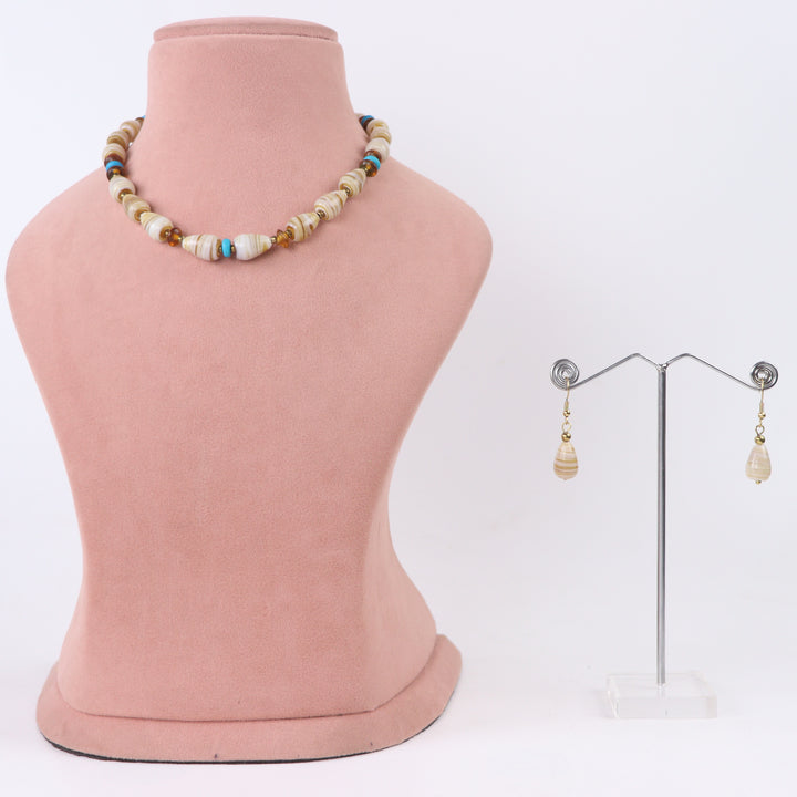 Delemon cream and beige swirl patterned glass bead choker necklace with turquoise accents and matching drop earrings on display mannequin.