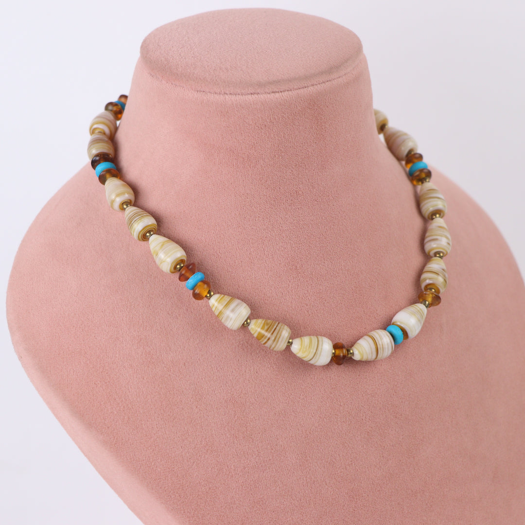 Delemon cream and beige swirl patterned glass bead choker necklace with turquoise accents and matching drop earrings on display mannequin.