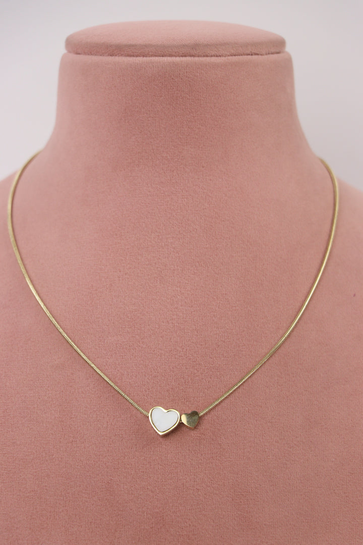 Delemon high-quality gold plated snake chain necklace with double heart charms displayed elegantly on a pink bust.
