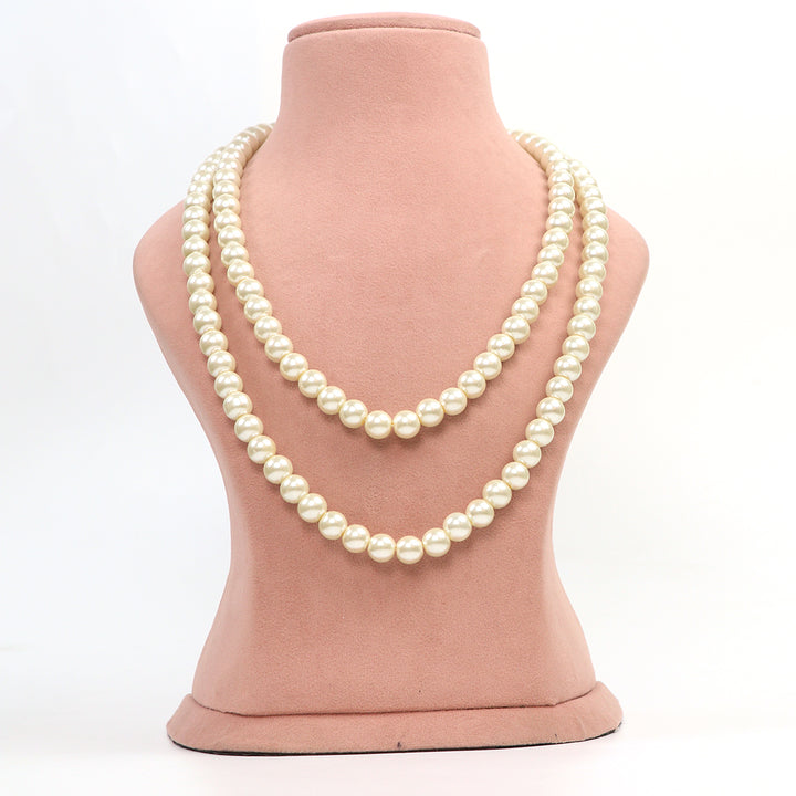 Delemon classic double strand off white pearl necklace on pink bust.