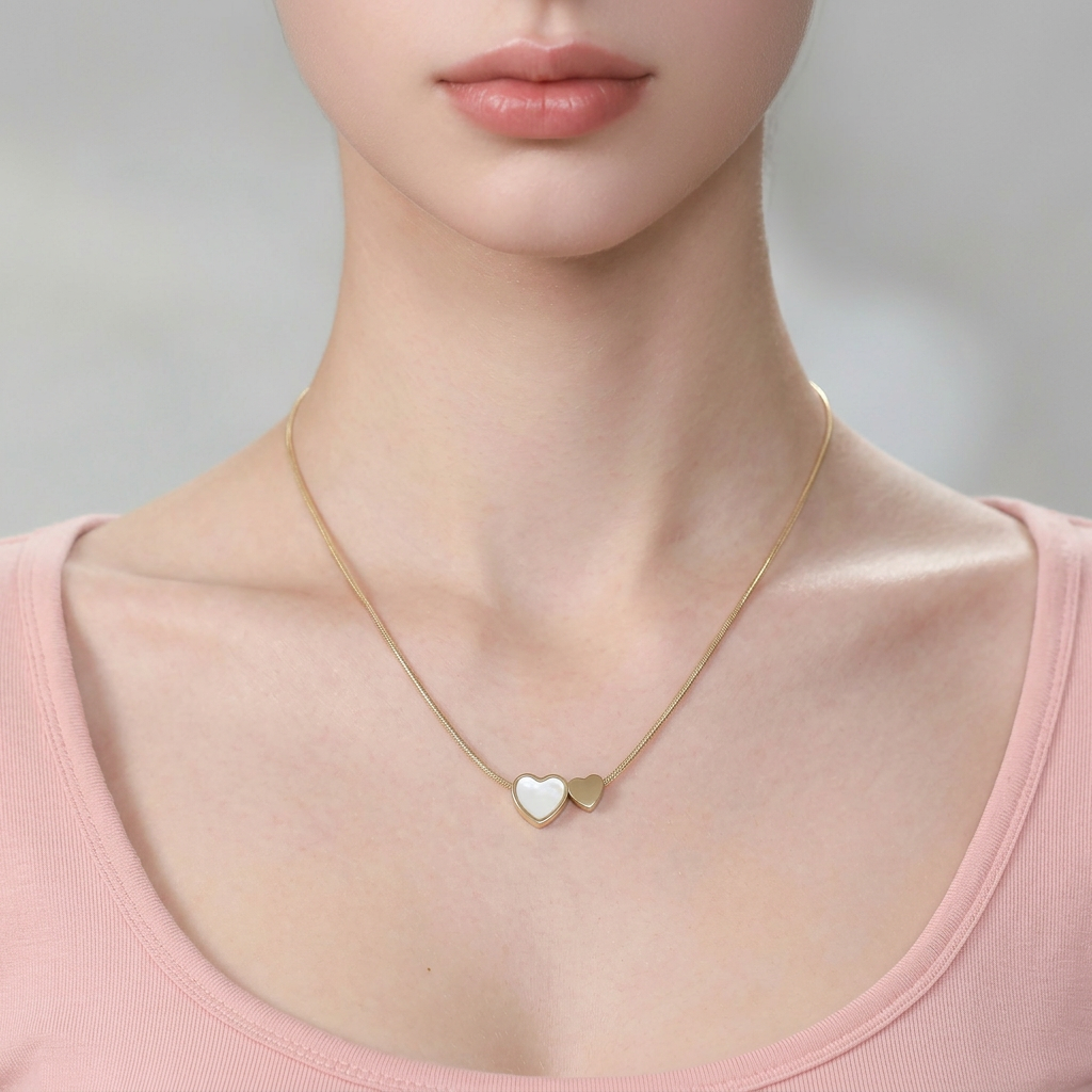 Delemon high-quality gold plated thin snake chain necklace featuring a central double heart pendant with one white mother-of-pearl heart and one smaller solid gold heart