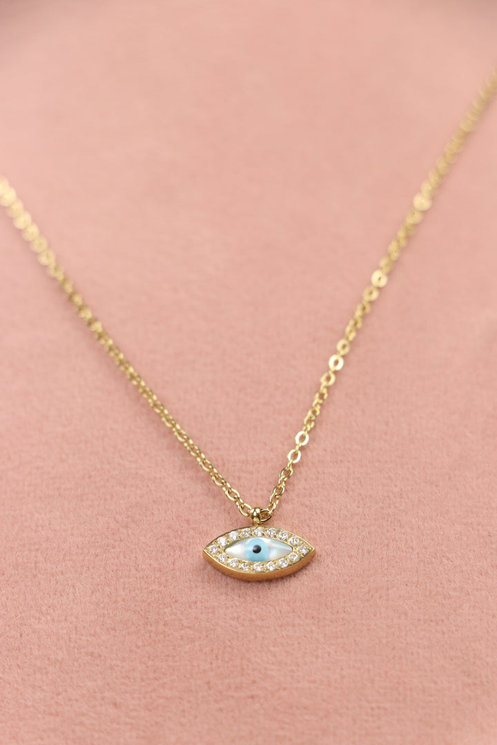 Delemon high-quality gold plated chain necklace featuring a small evil eye pendant with a mother-of-pearl center and crystal border close-up view.