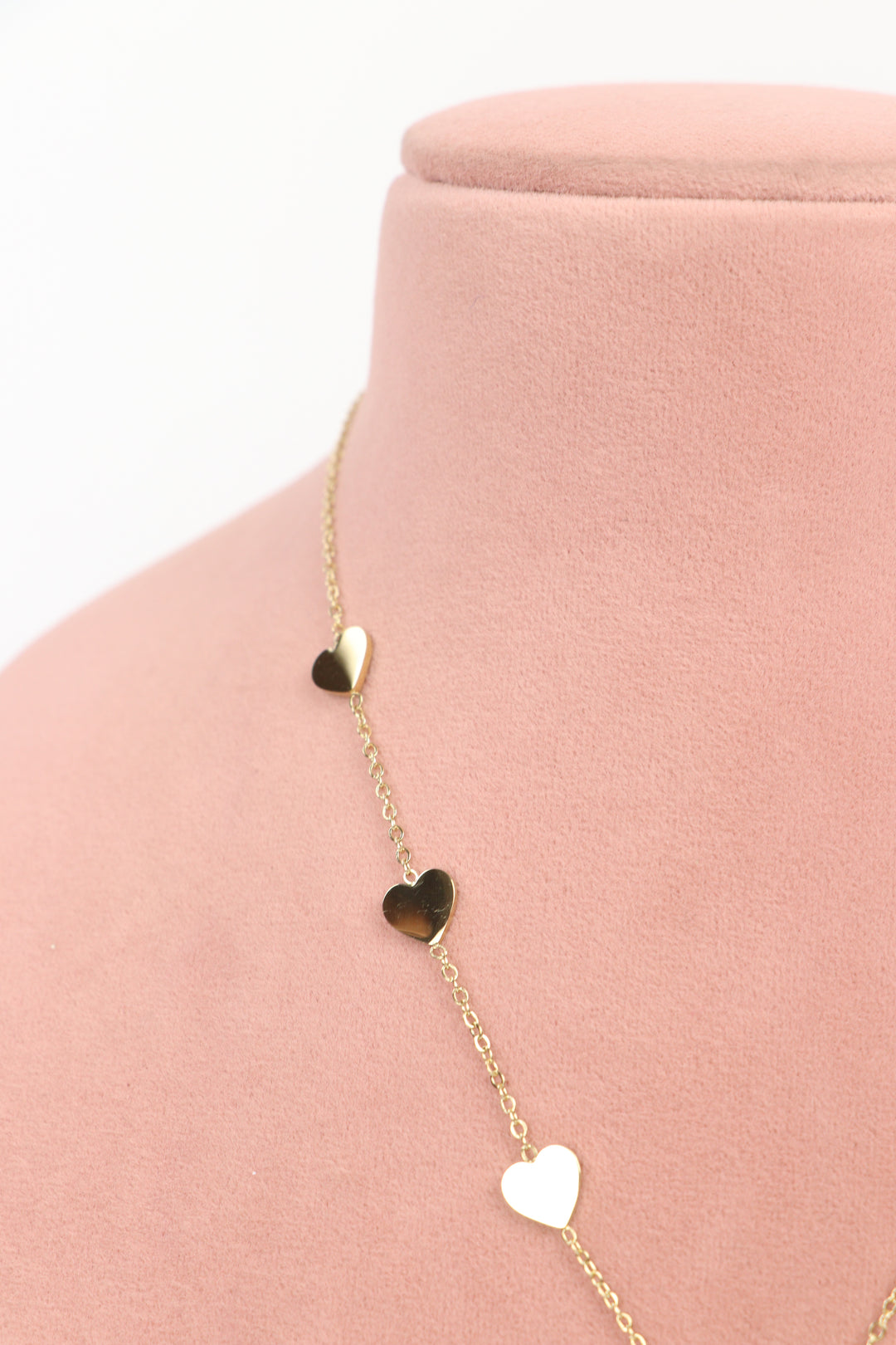 Delemon high-quality gold plated chain necklace featuring multiple delicate heart charms in a station design side close-up view.