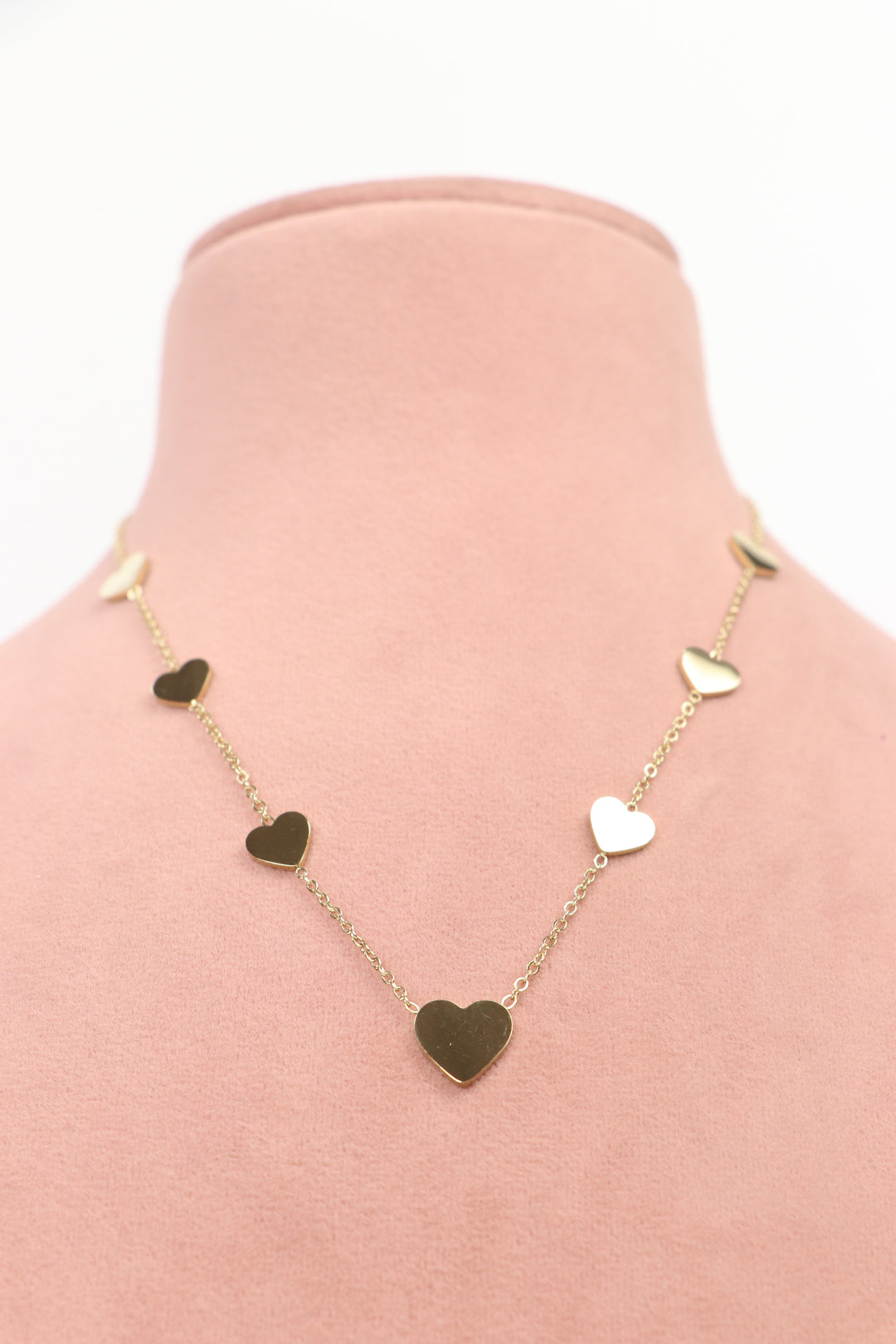 Delemon high-quality gold plated chain necklace featuring multiple delicate heart charms in a station design front view.