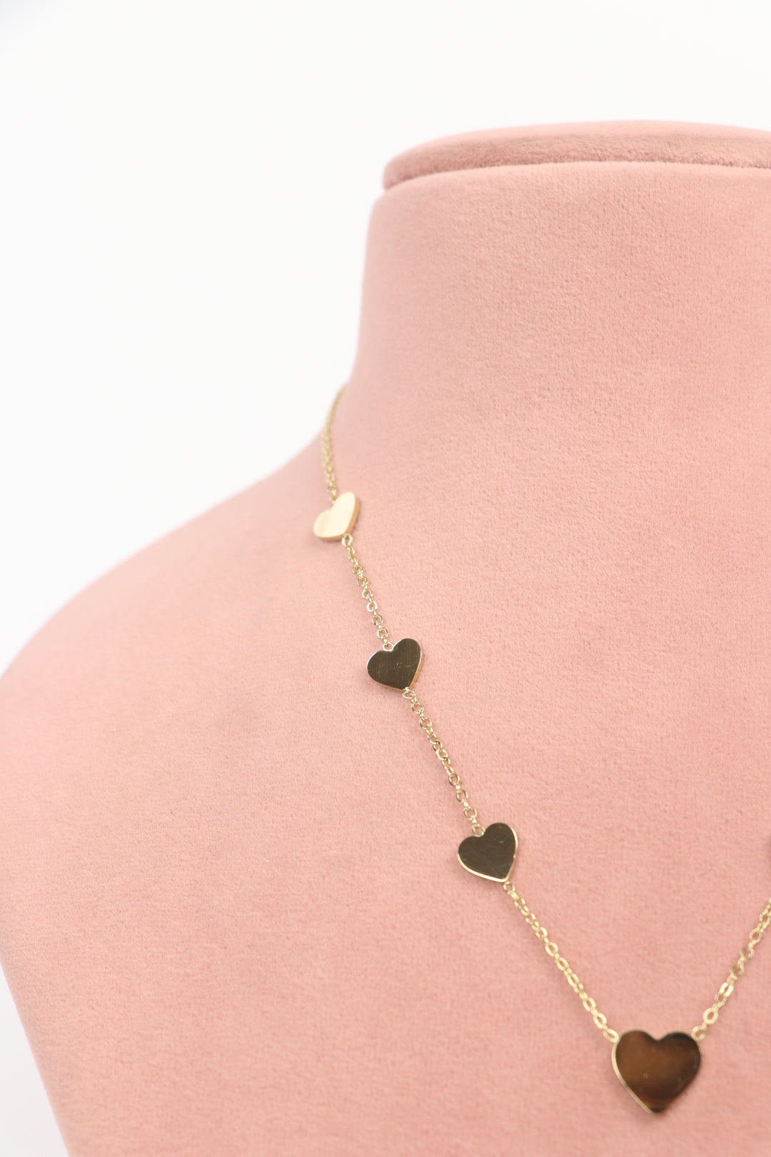 Delemon high-quality gold plated chain necklace featuring multiple delicate heart charms in a station design side close-up view.