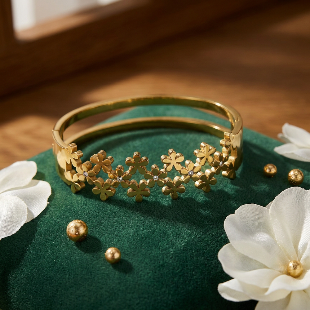 Delemon high-quality gold plated stainless steel bangle bracelet featuring an intricate clustered design of small five-petal flowers accented with delicate crystals
