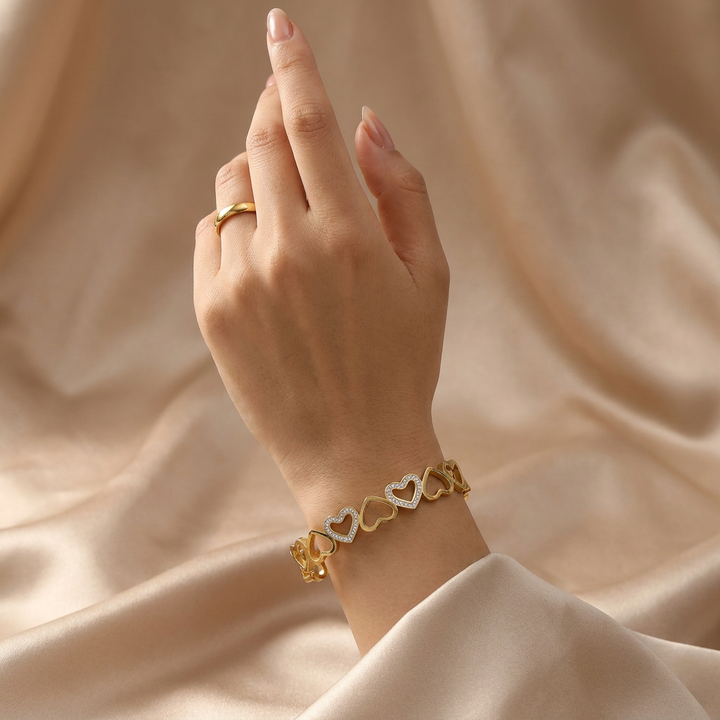 Delemon gold open-heart interlocking link bangle bracelet with alternating pavé crystal hearts in waterproof 18k gold plated stainless steel