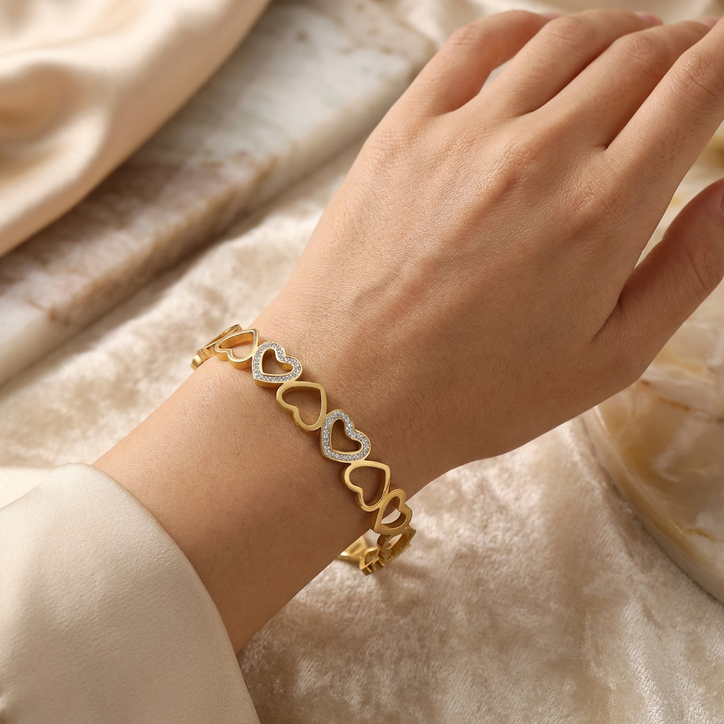 Delemon gold open-heart interlocking link bangle bracelet with alternating pavé crystal hearts in waterproof 18k gold plated stainless steel