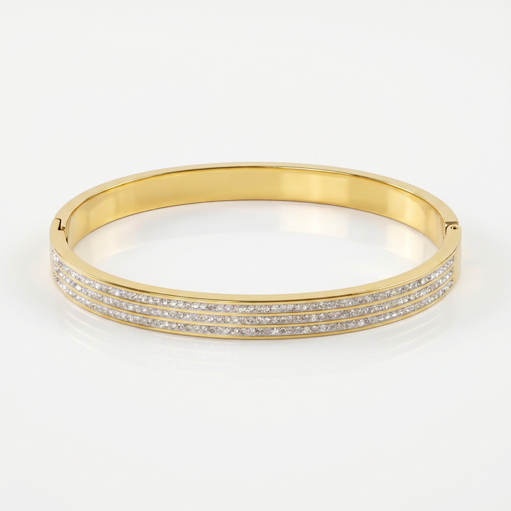 Delemon gold rigid bangle bracelet featuring three rows of clear pavé crystals in waterproof 18k gold plated stainless steel
