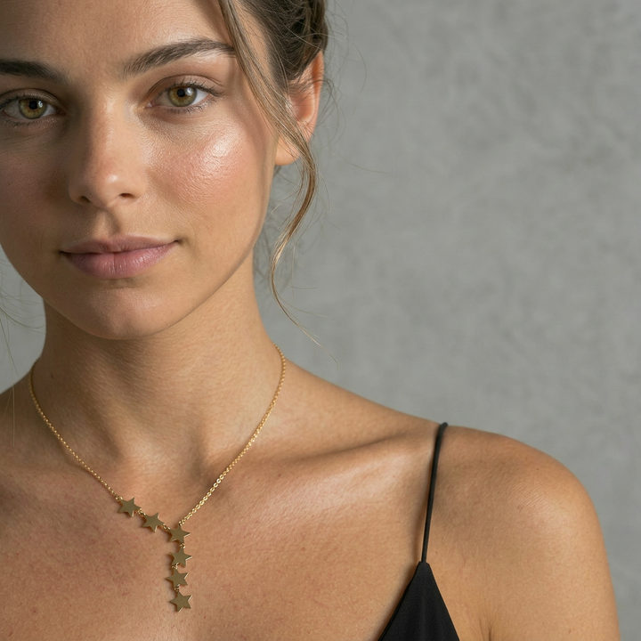 Delemon high-quality gold plated delicate chain necklace featuring an asymmetrical side-swept cascade of small star charms