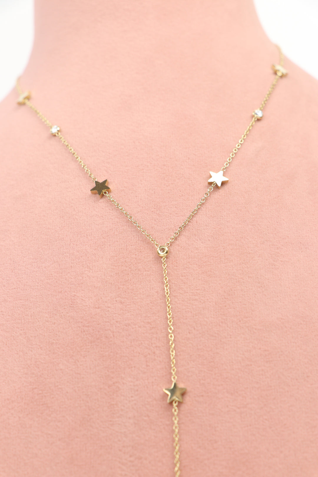 Delemon high-quality gold plated chain lariat necklace featuring star charms and small round crystals upper chest view.