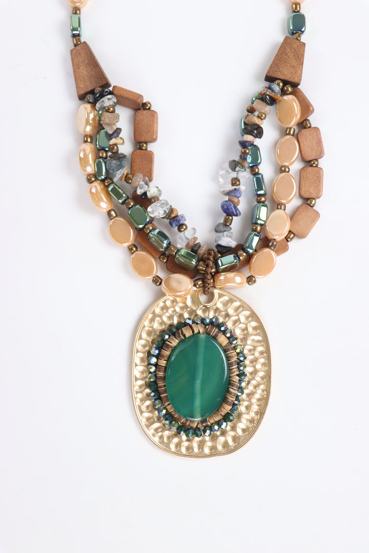 Delemon green cabochon stone on hammered gold oval pendant multi-strand wooden bead necklace