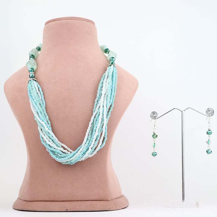 Delemon high-quality multi-strand beaded necklace in light blue and white seed beads, paired with matching drop earrings on a display stand.