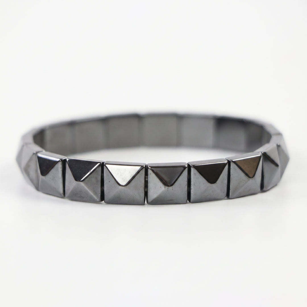 Delemon featuring a uniform geometric stretch bracelet with polished square-based pyramid stud hematite