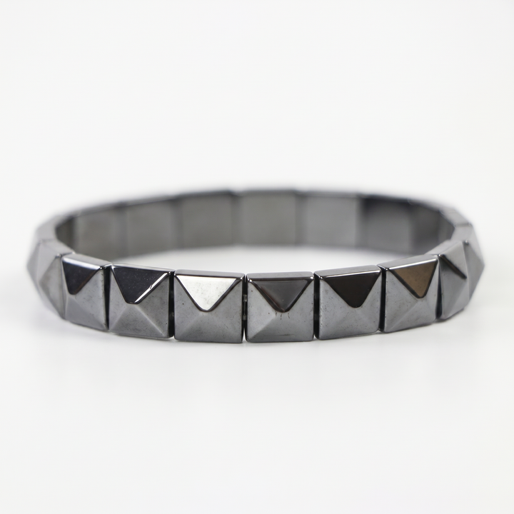 Delemon featuring a uniform geometric stretch bracelet with polished square-based pyramid stud hematite