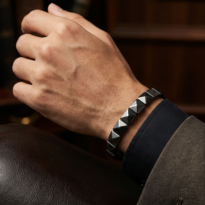 Delemon featuring a uniform geometric stretch bracelet with polished square-based pyramid stud hematite