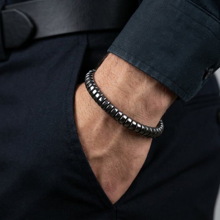 Delemon featuring a uniform stretch bracelet with softly rounded polished metallic hematite drum block beads