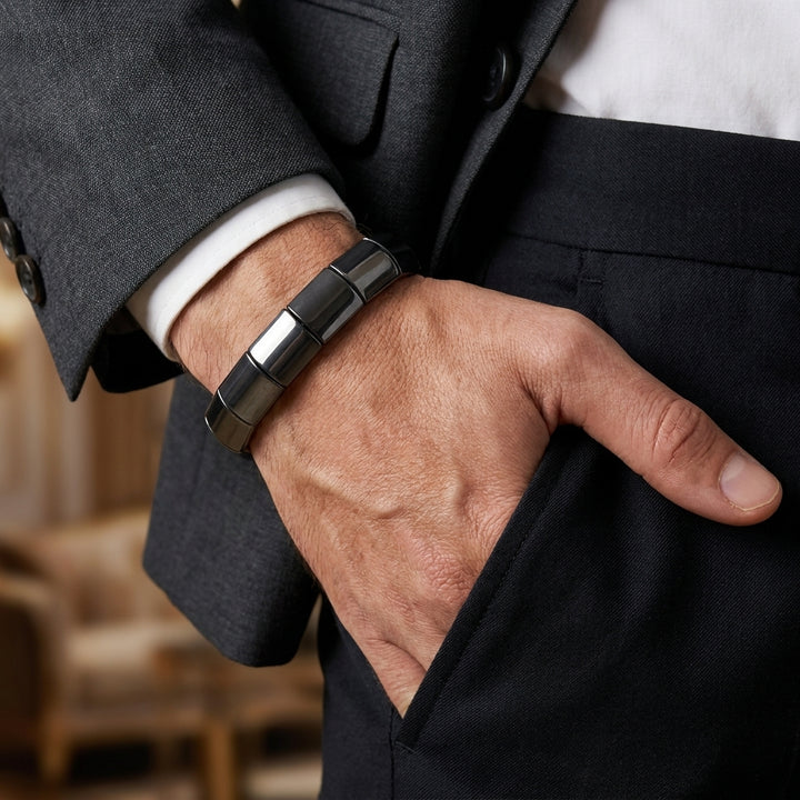 Delemon featuring a uniform chunkier stretch bracelet with large, wide flat-backed polished metallic hematite