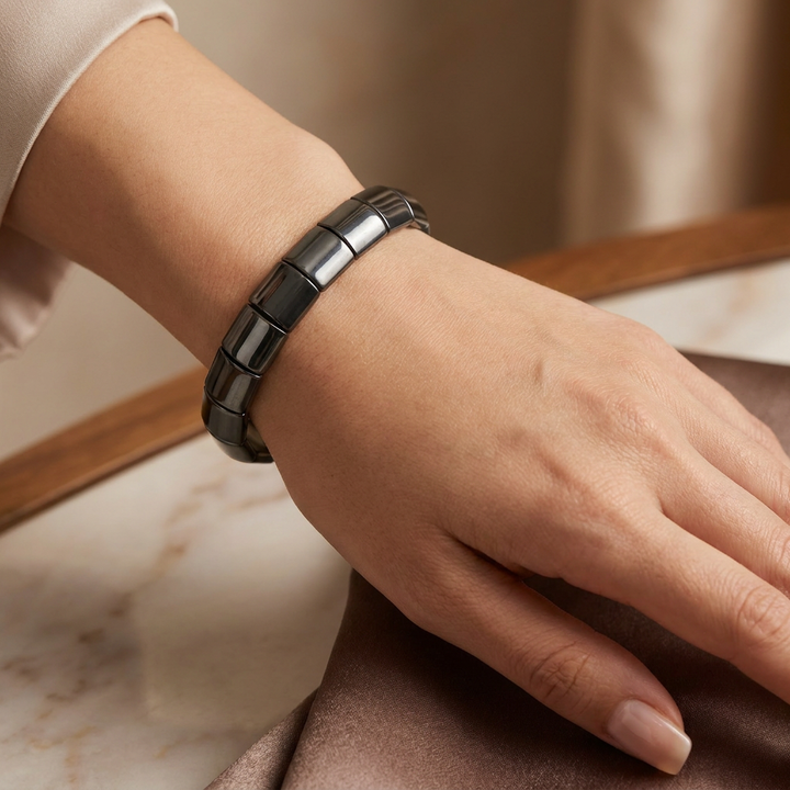 Delemon featuring a uniform chunkier stretch bracelet with large, wide flat-backed polished metallic hematite