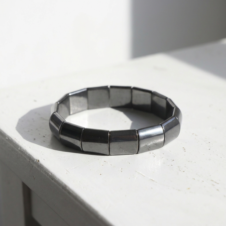 Delemon featuring a uniform chunkier stretch bracelet with large, wide flat-backed polished metallic hematite