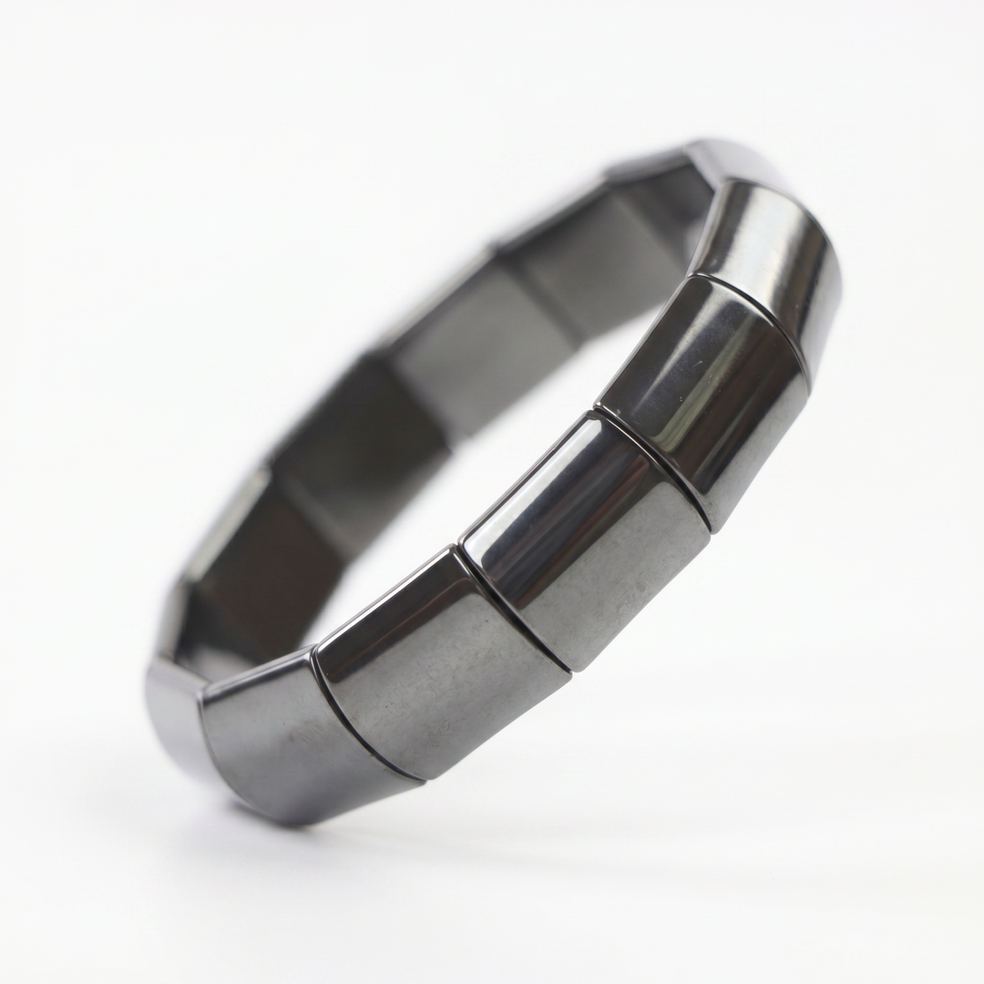 Delemon featuring a uniform chunkier stretch bracelet with large, wide flat-backed polished metallic hematite