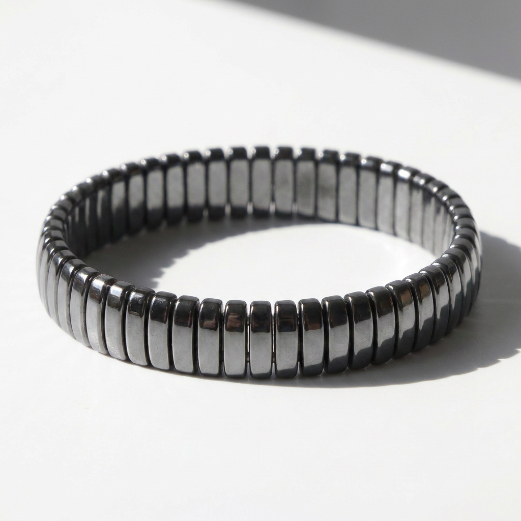 Delemon featuring a uniform full hematite block stretch bracelet with polished rectangular drum bead