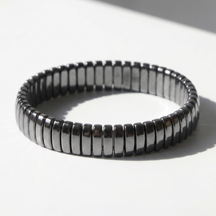 Delemon featuring a uniform full hematite block stretch bracelet with polished rectangular drum bead