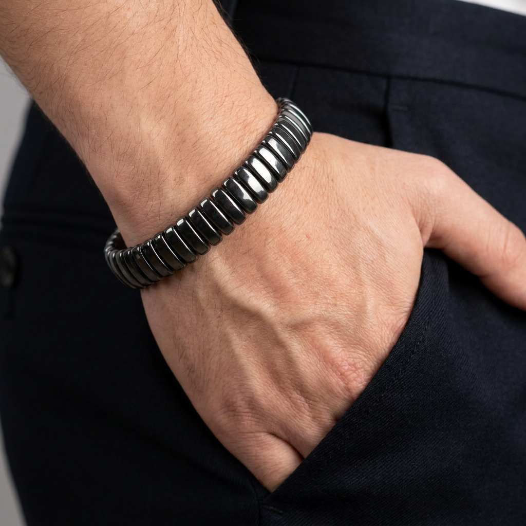 Delemon featuring a uniform full hematite block stretch bracelet with polished rectangular drum bead