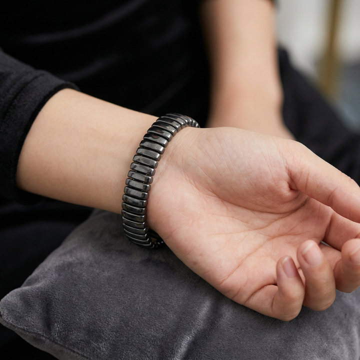 Delemon featuring a uniform full hematite block stretch bracelet with polished rectangular drum bead