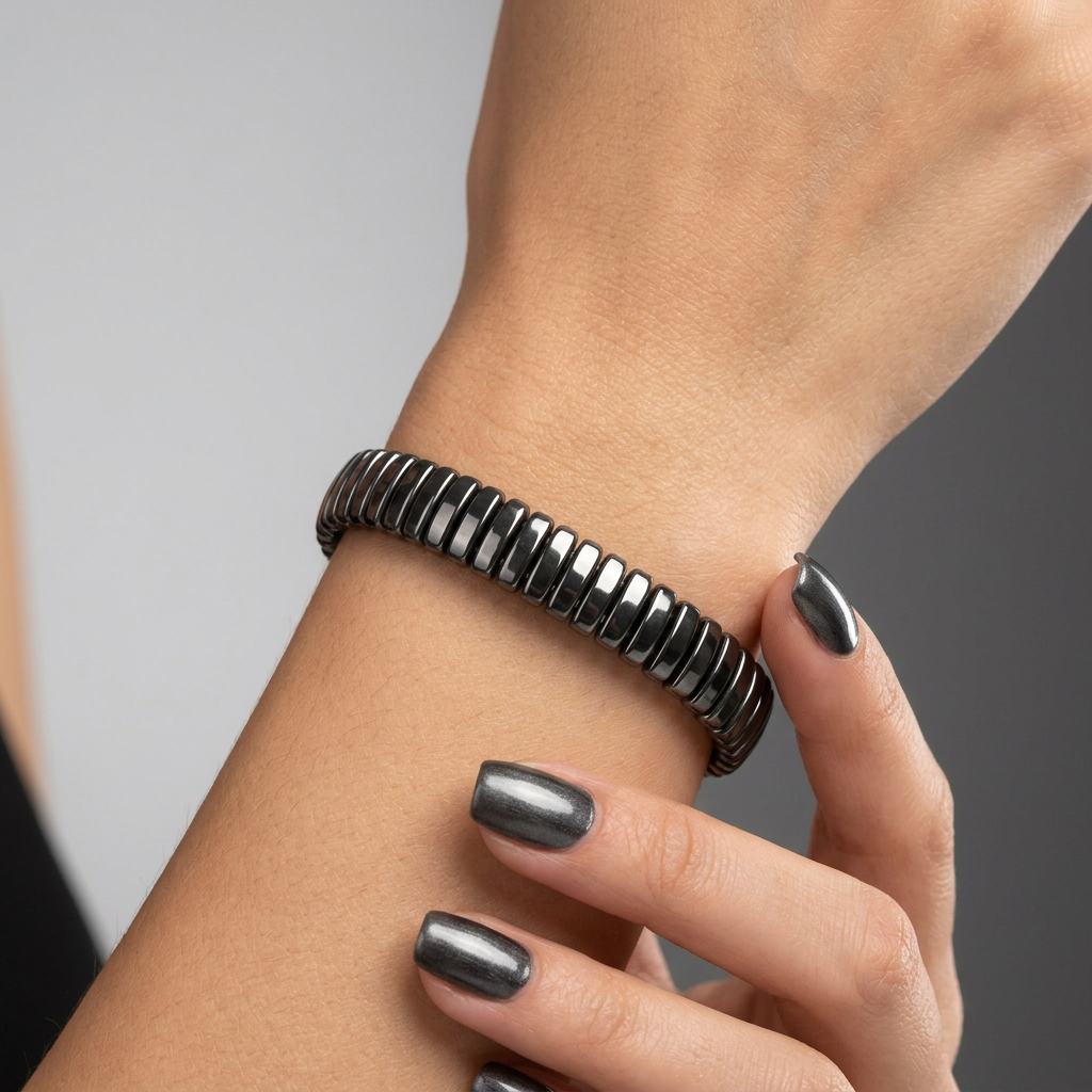 Delemon featuring a uniform full hematite block stretch bracelet with polished rectangular drum bead