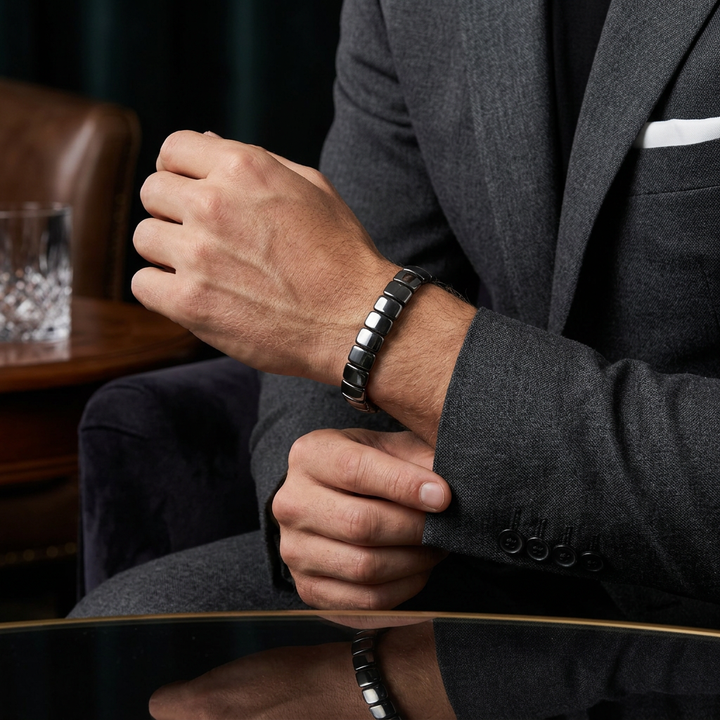 Delemon featuring a uniform stretch bracelet with wide, flat-backed polished metallic hematite
