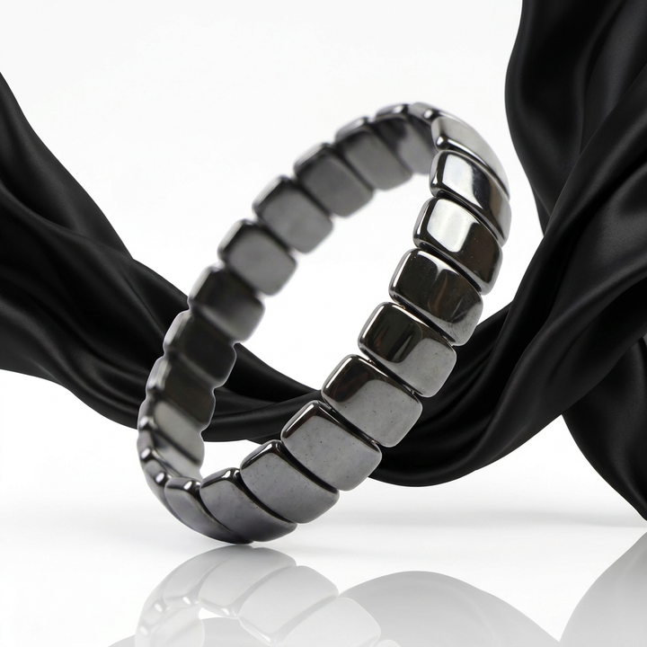Delemon featuring a uniform stretch bracelet with wide, flat-backed polished metallic hematite