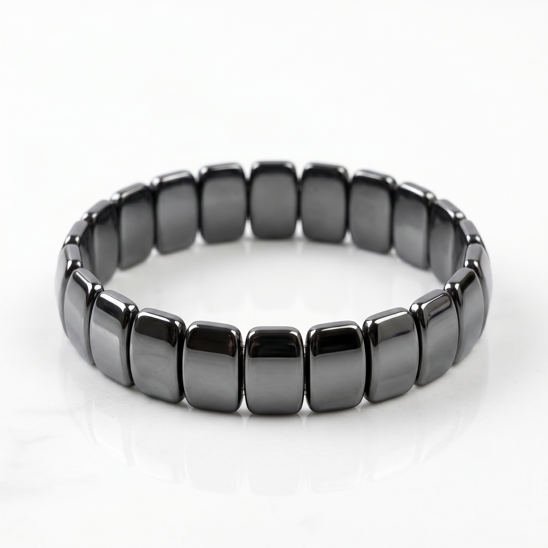 Delemon featuring a uniform stretch bracelet with wide, flat-backed polished metallic hematite