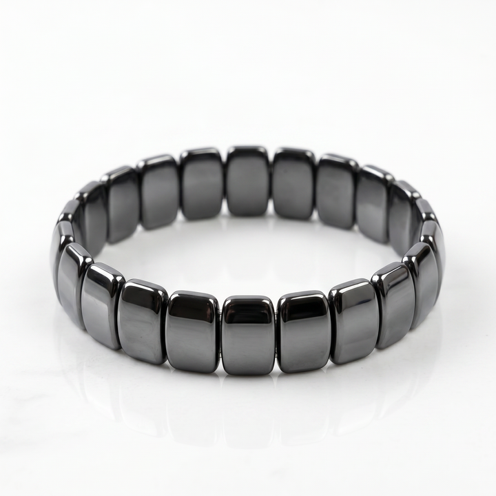 Delemon featuring a uniform stretch bracelet with wide, flat-backed polished metallic hematite