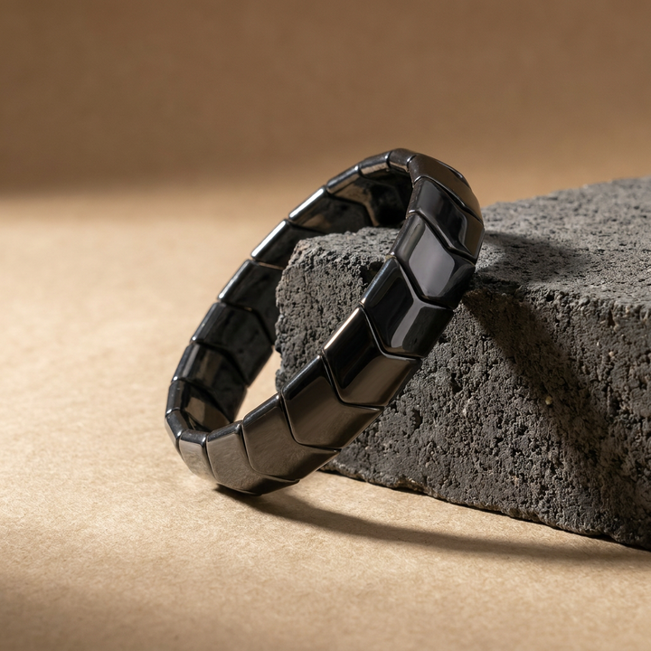 Delemon featuring a uniform chunkier directional stretch bracelet with wide, polished interlocking chevron arrowhead hematite