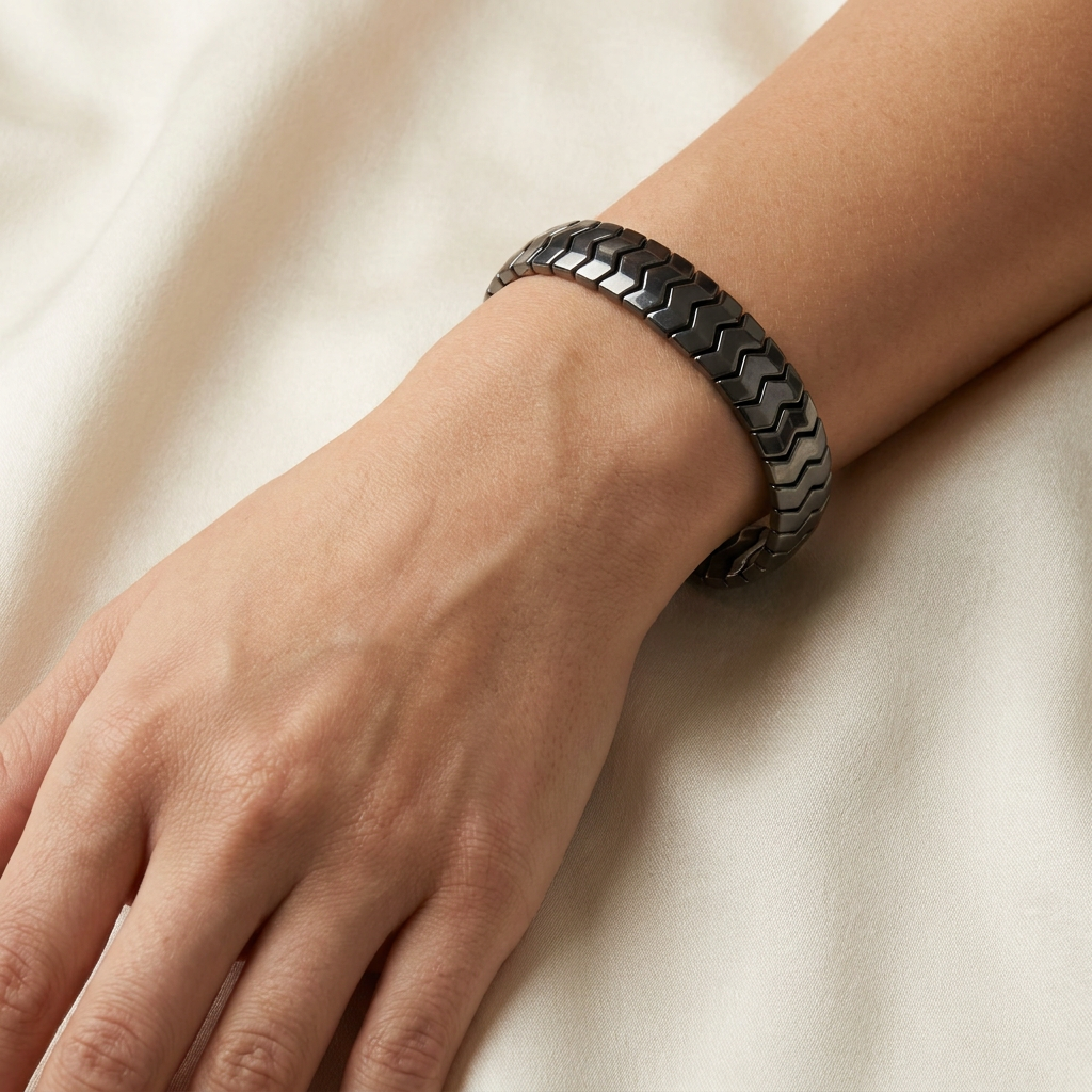 Delemon  featuring a uniform directional stretch bracelet with polished interlocking chevron arrowhead hematite