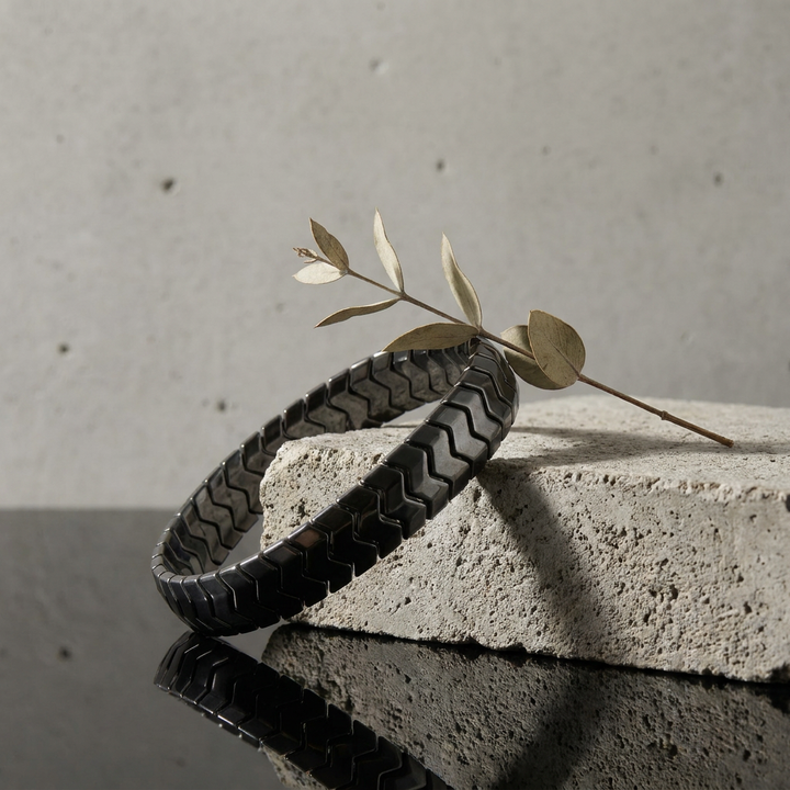 Delemon  featuring a uniform directional stretch bracelet with polished interlocking chevron arrowhead hematite