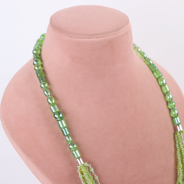 Olive green multi-strand seed bead necklace with chain accents and matching earrings on a pink display - delemon Collection.