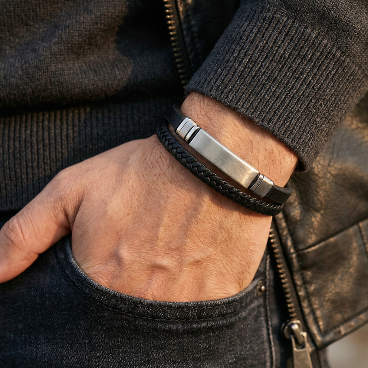   Delemon featuring a dual-strand black leather bracelet with a central brushed stainless steel