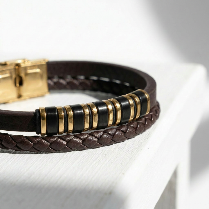 featuring a dual-strand brown leather bracelet with alternating gold and black metal ring