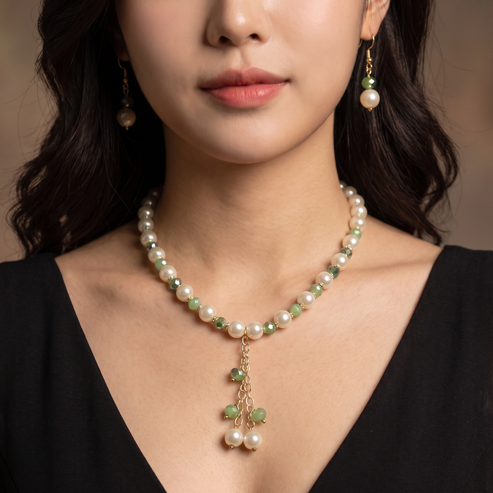 Delemon sage green crystal and cream pearl Y-drop necklace with matching drop earrings on display mannequin.